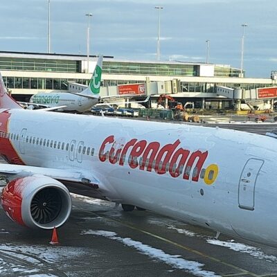 Corendon 737 MAX at a gate, partially covered with snow