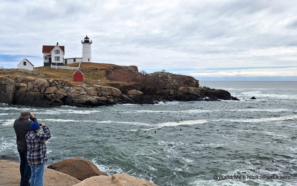 a lighthouse on a rocky cliff by the ocean