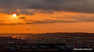 plane taking off into an orange sunset at LAX