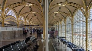 yellow arched ceiling of an airport terminal split by a vertical line