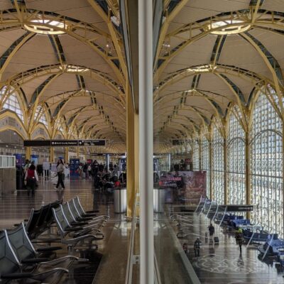 yellow arched ceiling of an airport terminal split by a vertical line