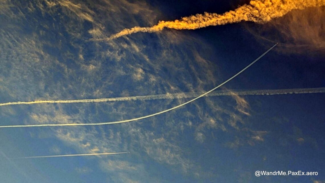 white contrails in a blue sky