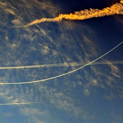 white contrails in a blue sky