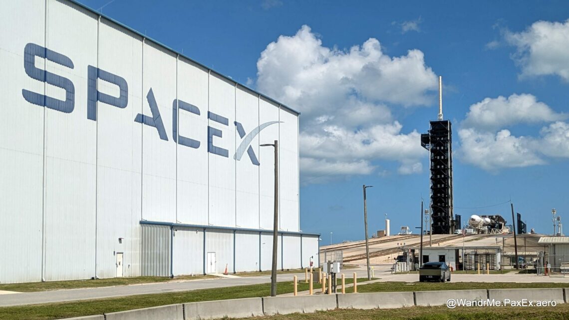 SpaceX hangar and a launch tower in the background.