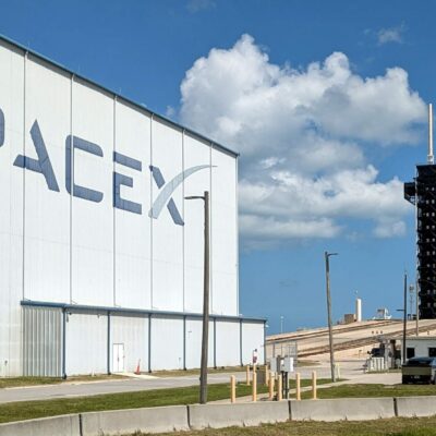 SpaceX hangar and a launch tower in the background.