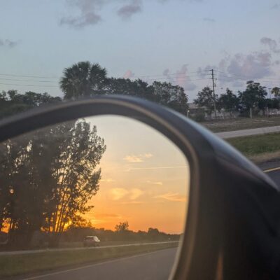sunset in a car rearview mirror