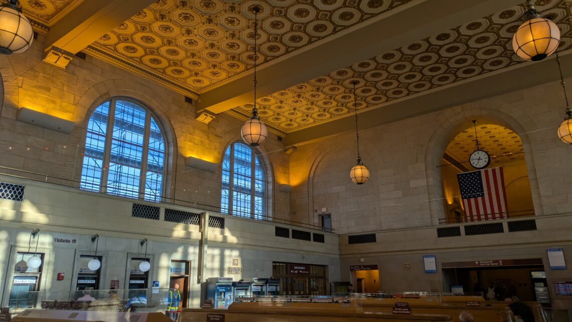 Interior of a high-ceiling train station waiting room