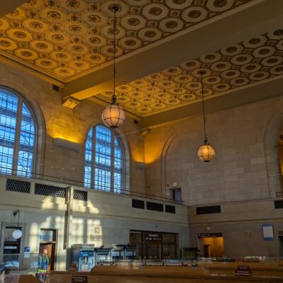 Interior of a high-ceiling train station waiting room