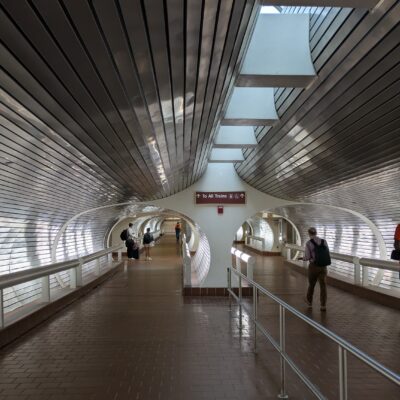 silver ceiling and walls in a train station tunnel