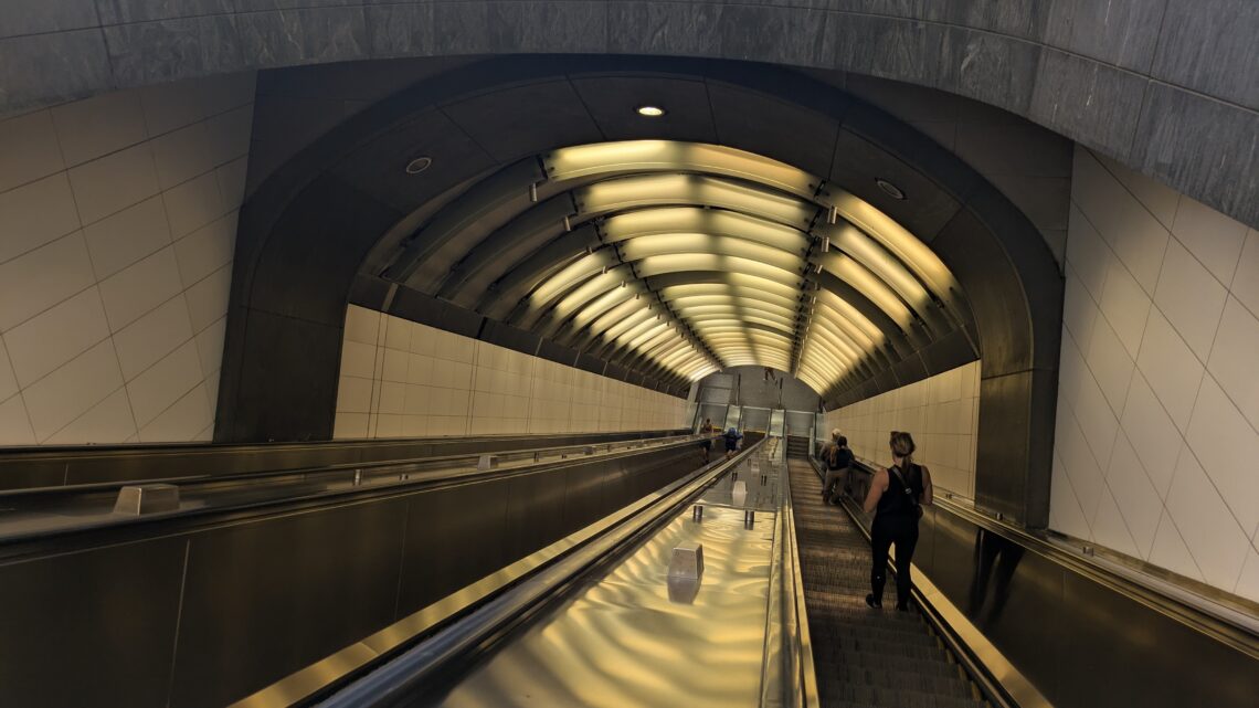 Escalators descending into a subway station