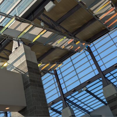 Interior of an airport, looking up at skylights.