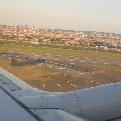 Shadow of a plane as seen from the window of that plane as it takes off.