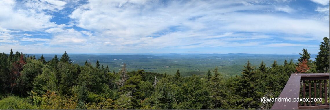 panorama of blue skies over green forests